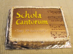 cake iced with: Scola Cantorum Happy 25th Anniversary - and some lines of music for Veni Creator